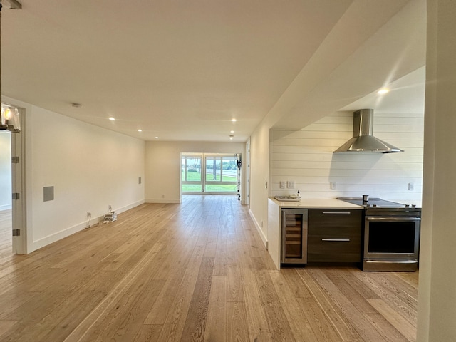 3 Colonial Club Dr Unit 104, Boynton Beach, FL 33435 - bar area featuring wall chimney exhaust hood, wine cooler, stainless steel electric range, light wood-style flooring, and baseboards