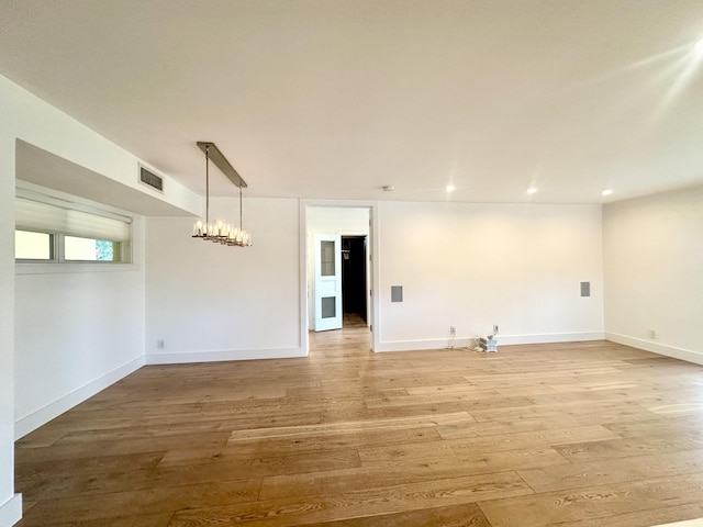 3 Colonial Club Dr Unit 104, Boynton Beach, FL 33435 - unfurnished room featuring light wood finished floors, a chandelier, baseboards, and recessed lighting
