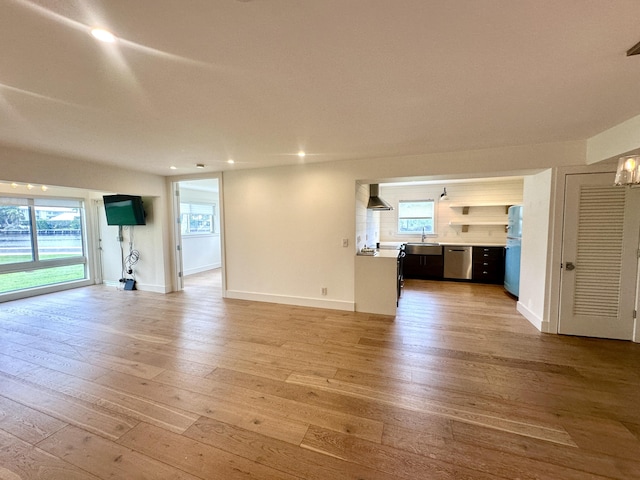 3 Colonial Club Dr Unit 104, Boynton Beach, FL 33435 - unfurnished living room featuring light wood-type flooring, recessed lighting, a sink, and baseboards