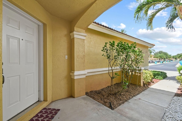 1007 Arezzo Cir, Boynton Beach, FL 33436 - view of exterior entry featuring stucco siding and a tiled roof