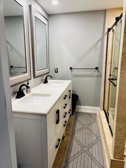 1714 17th Ct, Jupiter, FL 33477 - full bath with a stall shower, double vanity, and baseboards