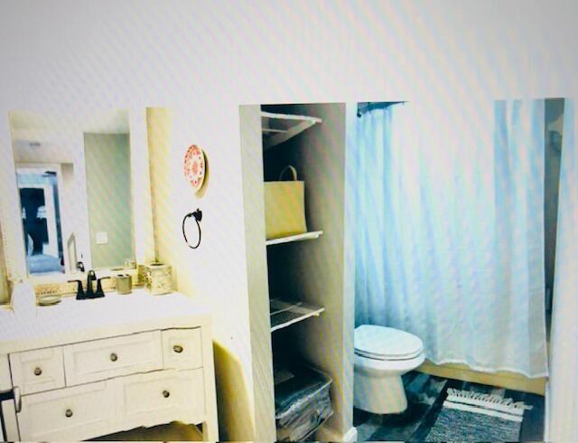 1714 17th Ct, Jupiter, FL 33477 - bathroom featuring toilet, vanity, and a shower with curtain