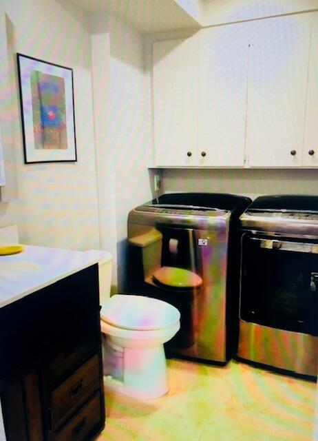 1714 17th Ct, Jupiter, FL 33477 - laundry room featuring washing machine and clothes dryer and cabinet space