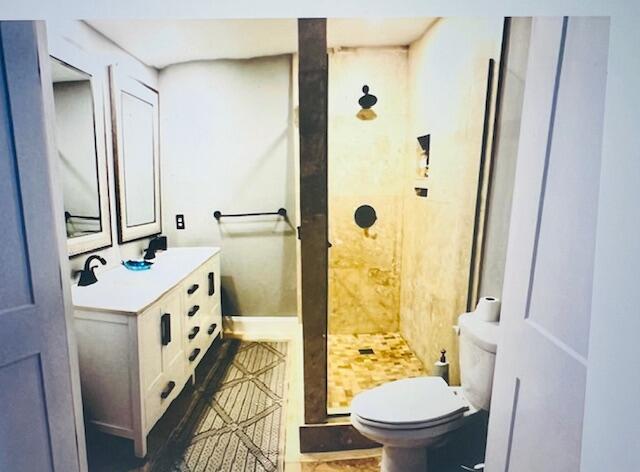 1714 17th Ct, Jupiter, FL 33477 - full bathroom featuring a stall shower, toilet, and double vanity
