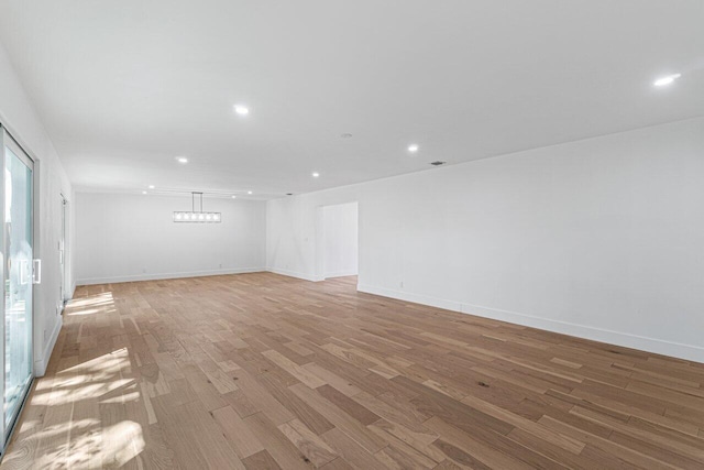 1188 W Camino Real, Boca Raton, FL 33486 - empty room featuring light wood-style flooring, recessed lighting, and baseboards