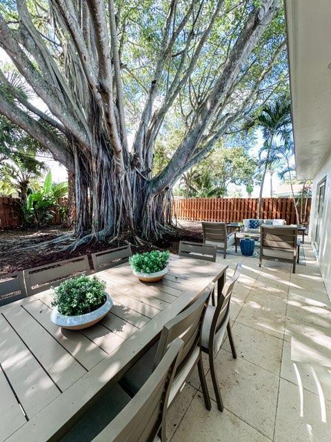 1188 W Camino Real, Boca Raton, FL 33486 - fenced backyard featuring an outdoor living space, a patio area, and outdoor dining area