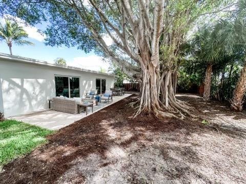 1188 W Camino Real, Boca Raton, FL 33486 - view of yard featuring a patio and outdoor lounge area