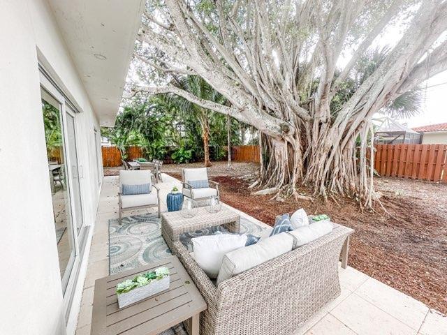 1188 W Camino Real, Boca Raton, FL 33486 - fenced backyard featuring a patio and an outdoor living space