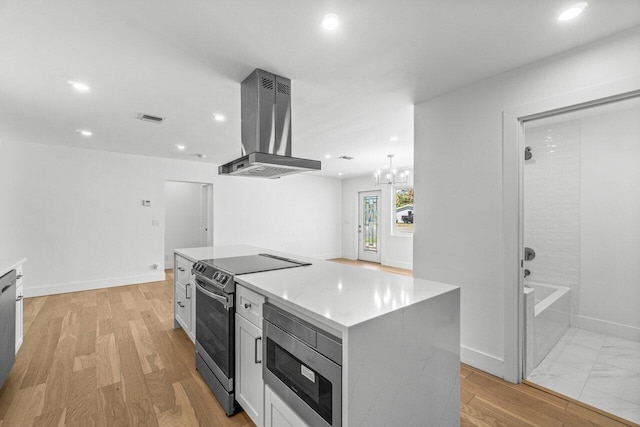 1188 W Camino Real, Boca Raton, FL 33486 - kitchen featuring appliances with stainless steel finishes, island range hood, recessed lighting, a chandelier, and a kitchen island