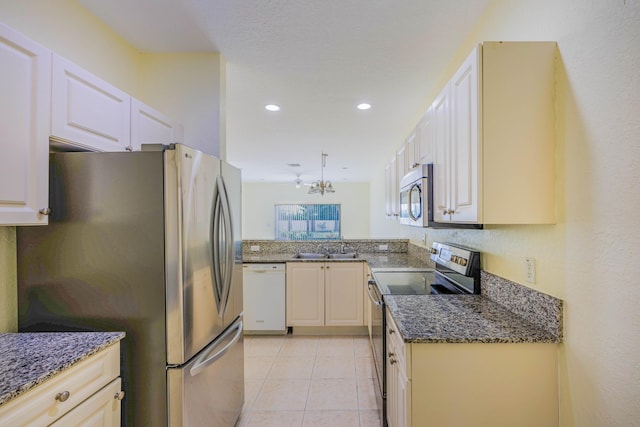 5441 Via Delray Unit 17, Delray Beach, FL 33484 - kitchen with appliances with stainless steel finishes, a sink, dark stone counters, light tile patterned floors, and recessed lighting
