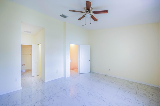 5441 Via Delray Unit 17, Delray Beach, FL 33484 - unfurnished bedroom featuring light marble finish flooring, baseboards, connected bathroom, and a ceiling fan