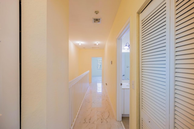 5441 Via Delray Unit 17, Delray Beach, FL 33484 - hall with light marble finish floors and a wainscoted wall
