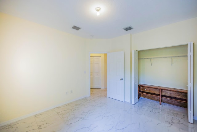 5441 Via Delray Unit 17, Delray Beach, FL 33484 - unfurnished bedroom featuring light marble finish floors, baseboards, and a closet