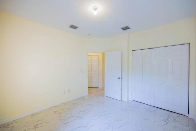 5441 Via Delray Unit 17, Delray Beach, FL 33484 - unfurnished bedroom with light marble finish floors, baseboards, and a closet