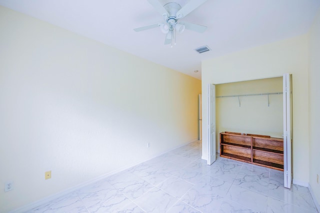 5441 Via Delray Unit 17, Delray Beach, FL 33484 - unfurnished bedroom with light marble finish flooring, a closet, ceiling fan, and baseboards