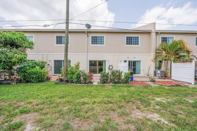 5441 Via Delray Unit 17, Delray Beach, FL 33484 - back of house featuring central AC, stucco siding, and a lawn