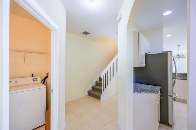 5441 Via Delray Unit 17, Delray Beach, FL 33484 - washroom with washer / clothes dryer, recessed lighting, baseboards, light tile patterned flooring, and arched walkways