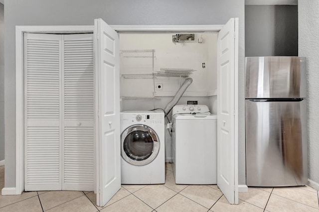 332 S E St, Lake Worth Beach, FL 33460 - laundry room with light tile patterned floors and washing machine and clothes dryer