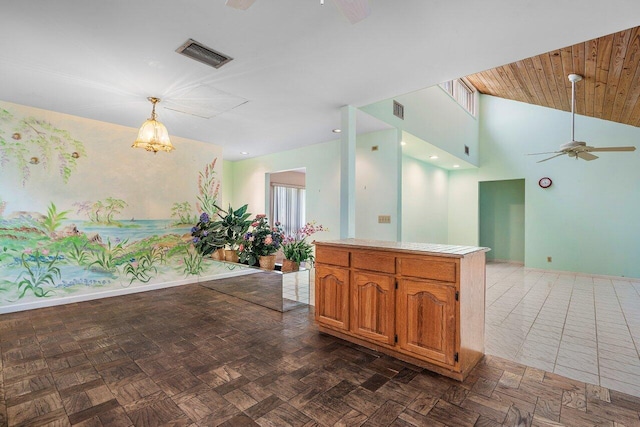 4744 Dolphin Dr, Lake Worth, FL 33463 - kitchen with a ceiling fan, a chandelier, vaulted ceiling, baseboards, and light countertops