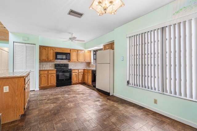 4744 Dolphin Dr, Lake Worth, FL 33463 - kitchen with black appliances, baseboards, light countertops, decorative backsplash, and a ceiling fan