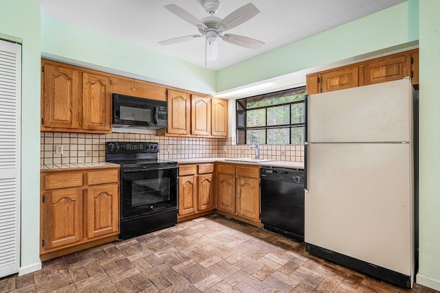 4744 Dolphin Dr, Lake Worth, FL 33463 - kitchen with black appliances, a sink, tile countertops, tasteful backsplash, and a ceiling fan