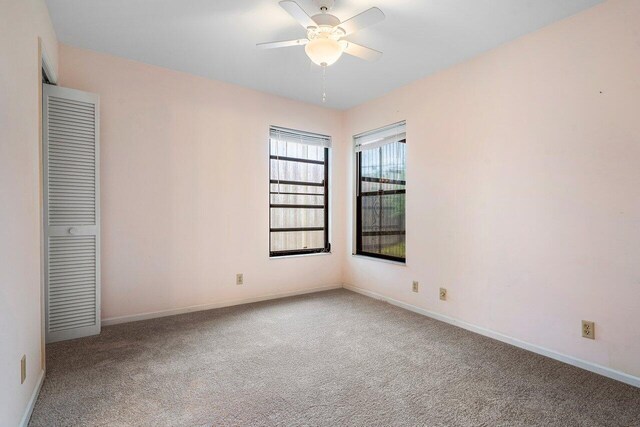 4744 Dolphin Dr, Lake Worth, FL 33463 - unfurnished bedroom with carpet flooring, baseboards, and ceiling fan