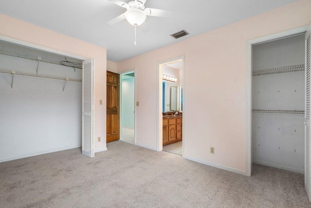 4744 Dolphin Dr, Lake Worth, FL 33463 - unfurnished bedroom with light carpet, baseboards, ensuite bathroom, and a ceiling fan