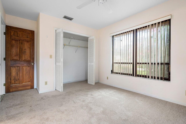 4744 Dolphin Dr, Lake Worth, FL 33463 - unfurnished bedroom featuring carpet flooring, a closet, baseboards, and a ceiling fan