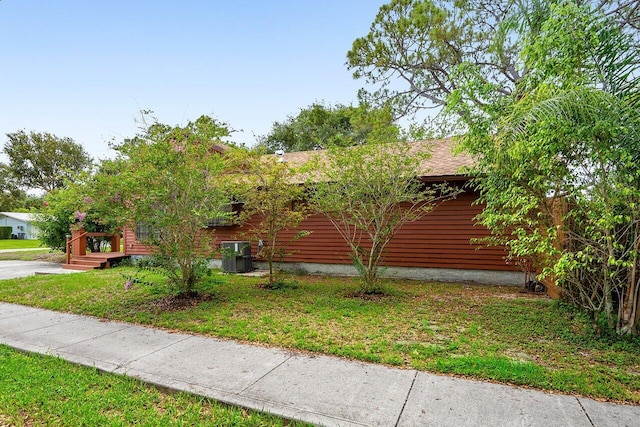 4744 Dolphin Dr, Lake Worth, FL 33463 - view of side of home with a yard and cooling unit