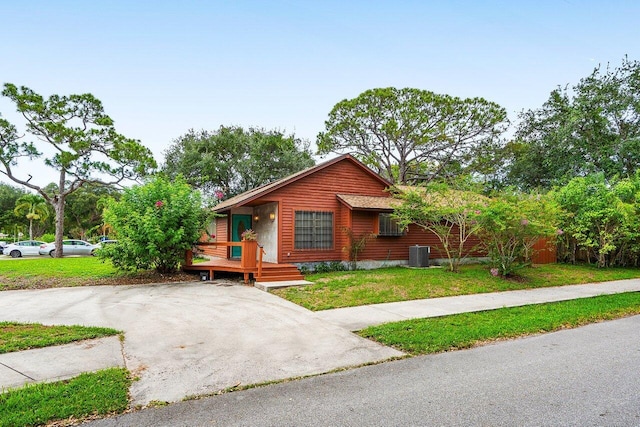 4744 Dolphin Dr, Lake Worth, FL 33463 - view of front facade featuring central air condition unit and a front yard