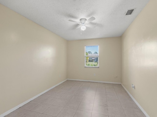 526 NW Kingston St, Port Saint Lucie, FL 34983 - unfurnished room featuring a ceiling fan, a textured ceiling, light tile patterned floors, and baseboards