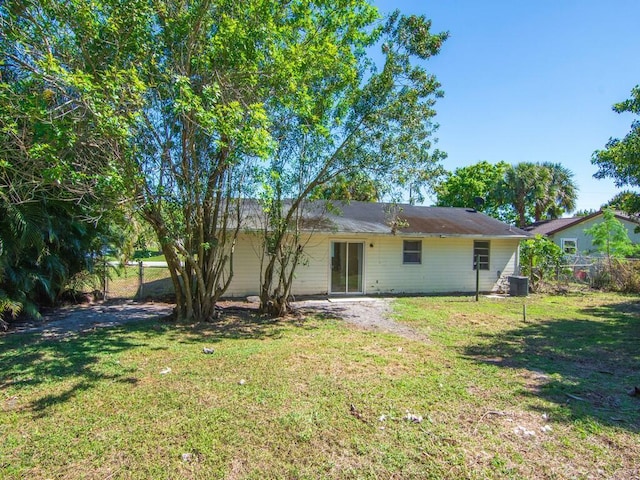 526 NW Kingston St, Port Saint Lucie, FL 34983 - rear view of property with central air condition unit