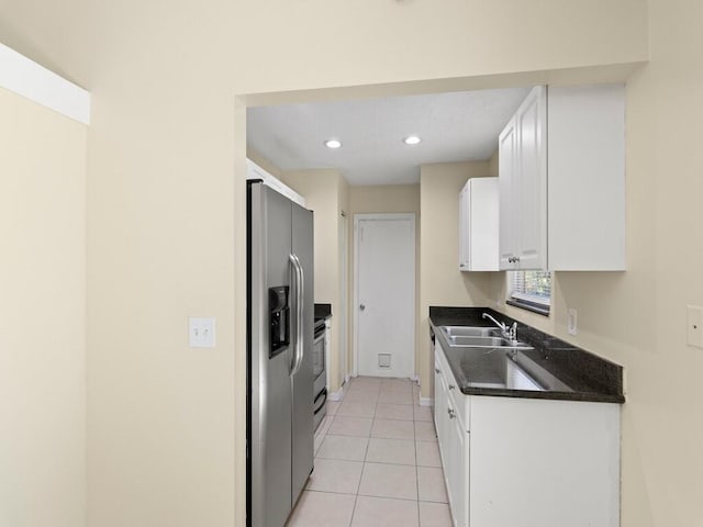 526 NW Kingston St, Port Saint Lucie, FL 34983 - kitchen with stainless steel appliances, a sink, dark countertops, white cabinets, and recessed lighting