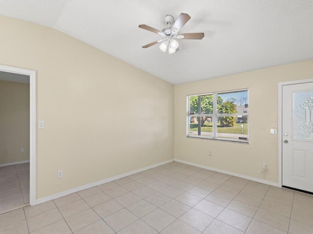 526 NW Kingston St, Port Saint Lucie, FL 34983 - spare room featuring vaulted ceiling, a ceiling fan, light tile patterned floors, and baseboards