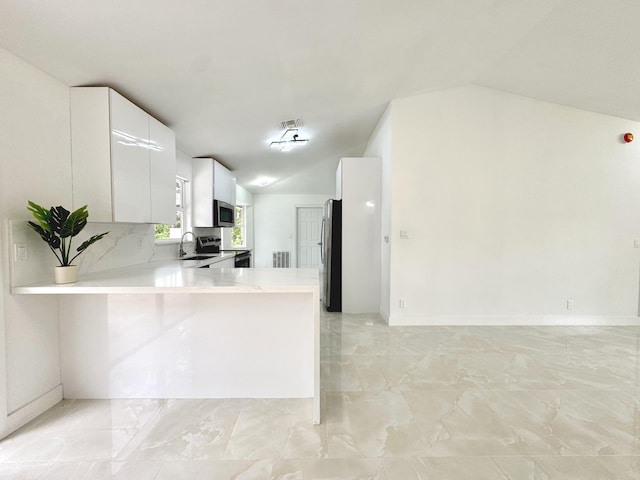 15809 85th Rd N, The Acreage, FL 33470 - kitchen featuring vaulted ceiling, a sink, stainless steel appliances, light countertops, and light marble finish flooring