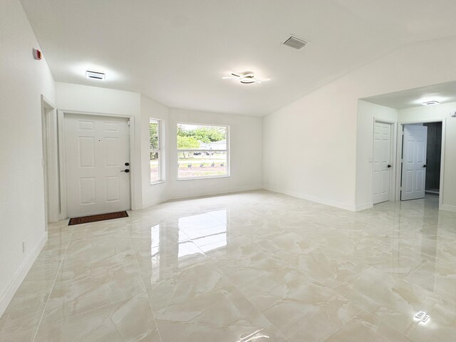 15809 85th Rd N, The Acreage, FL 33470 - foyer with light marble finish floors, baseboards, and vaulted ceiling
