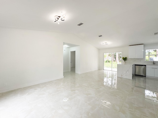 15809 85th Rd N, The Acreage, FL 33470 - unfurnished living room featuring vaulted ceiling, light marble finish flooring, baseboards, and a sink