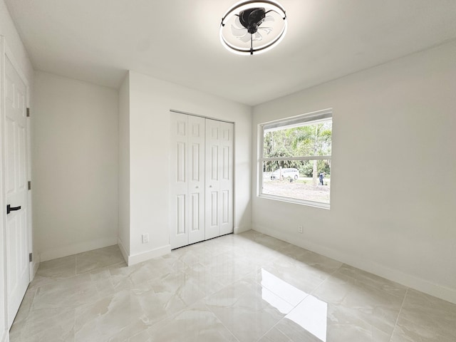 15809 85th Rd N, The Acreage, FL 33470 - unfurnished bedroom with baseboards, light marble finish floors, and a closet