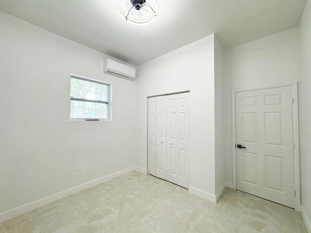 15809 85th Rd N, The Acreage, FL 33470 - unfurnished bedroom featuring a wall mounted air conditioner, baseboards, light marble finish floors, and a closet