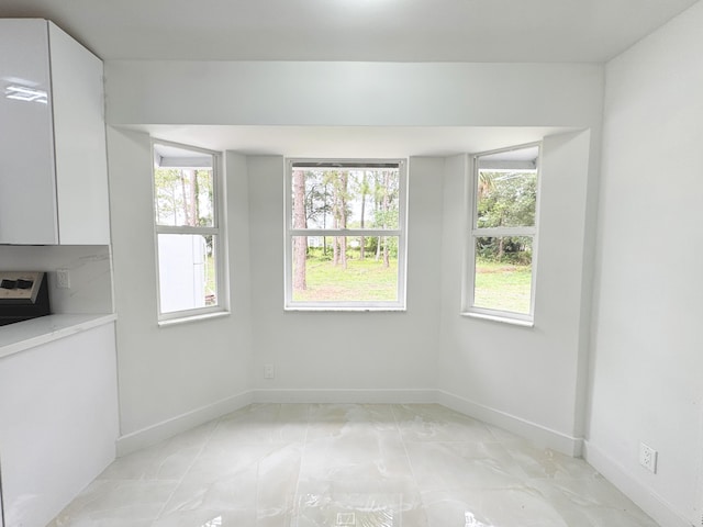 15809 85th Rd N, The Acreage, FL 33470 - unfurnished dining area featuring baseboards and light marble finish floors