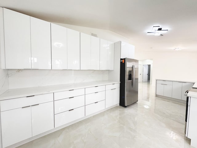 15809 85th Rd N, The Acreage, FL 33470 - kitchen with stainless steel fridge with ice dispenser, modern cabinets, light marble finish flooring, and white cabinets