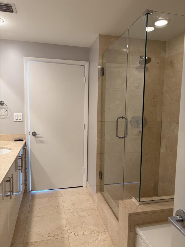 550 Okeechobee Blvd Unit 825, West Palm Beach, FL 33401 - bathroom with vanity, marble look tile flooring, and a shower stall