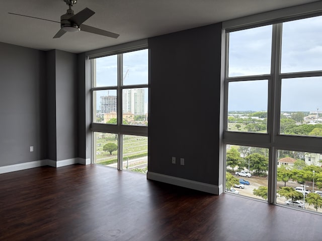 550 Okeechobee Blvd Unit 825, West Palm Beach, FL 33401 - spare room featuring baseboards, dark wood-type flooring, and a ceiling fan
