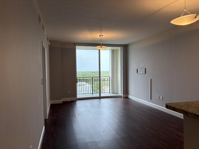 550 Okeechobee Blvd Unit 825, West Palm Beach, FL 33401 - spare room featuring floor to ceiling windows, baseboards, and dark wood-style flooring
