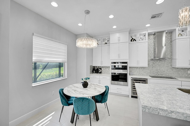 5452 Macoon Way, Westlake, FL 33470 - kitchen featuring a chandelier, wall chimney exhaust hood, beverage cooler, backsplash, and recessed lighting