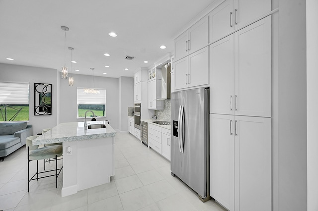 5452 Macoon Way, Westlake, FL 33470 - kitchen featuring stainless steel appliances, a sink, wall chimney range hood, a kitchen island with sink, and backsplash