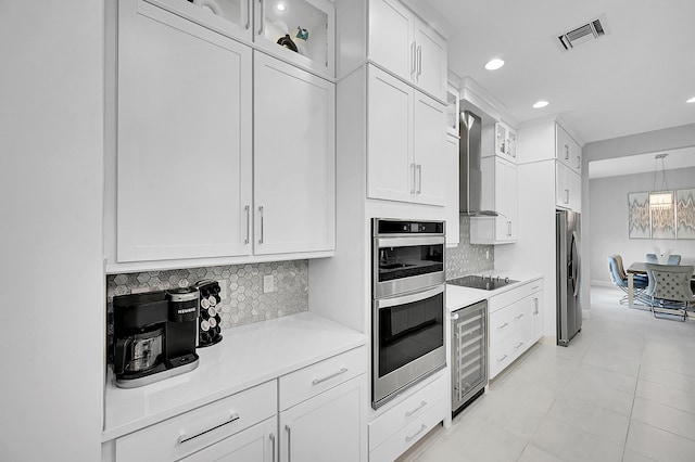5452 Macoon Way, Westlake, FL 33470 - kitchen with wine cooler, appliances with stainless steel finishes, light countertops, white cabinetry, and backsplash