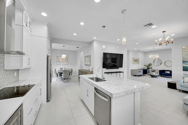 5452 Macoon Way, Westlake, FL 33470 - kitchen with open floor plan, a sink, wall chimney exhaust hood, stainless steel appliances, and a chandelier