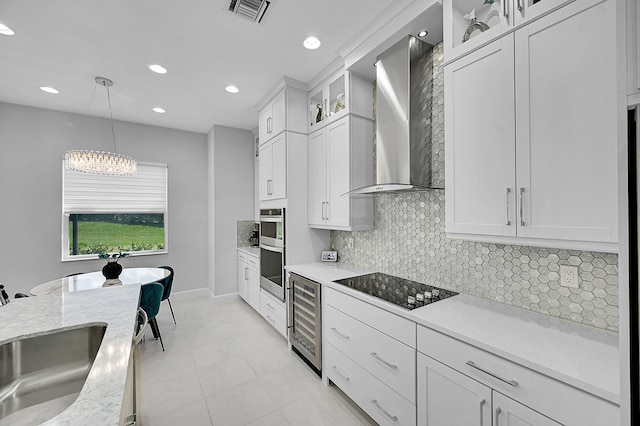 5452 Macoon Way, Westlake, FL 33470 - kitchen featuring beverage cooler, black electric cooktop, wall chimney range hood, decorative backsplash, and pendant lighting