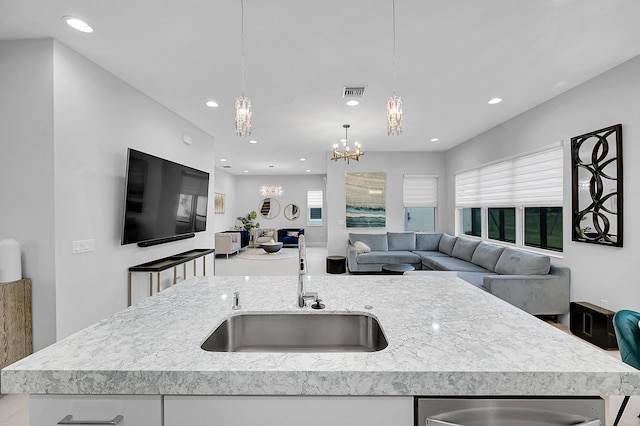 5452 Macoon Way, Westlake, FL 33470 - kitchen featuring a sink, a chandelier, open floor plan, light stone counters, and recessed lighting